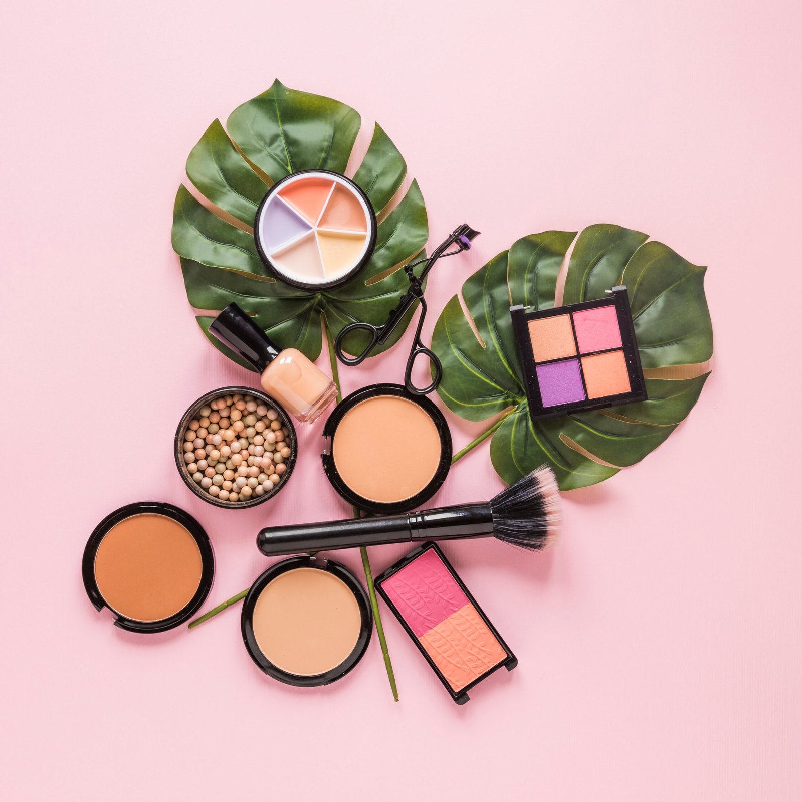 facial-powders-with-nail-polish-leaves-pink-table